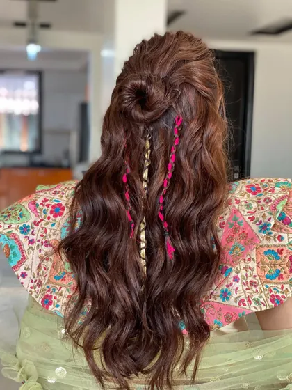 Blooming mehendi hair. This half-up top knot with colorful braided threads is a fun, festive look that has amazing volume thanks to my extensions.