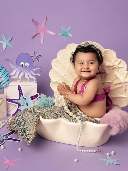 Diving into a world of imagination with this adorable mermaid session. My studio is filled with enchanting props like this seashell to bring your little one's fairytale dreams to life.