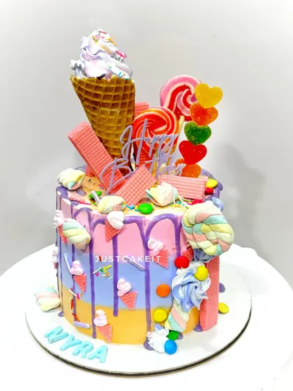 Another version of the candy theme cake, this one with a pastel rainbow drip. It's a fun, vibrant cake that's perfect for a sweet celebration.