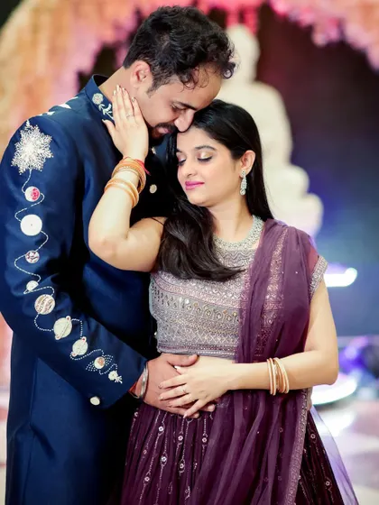 A tender moment between an engaged couple. The groom's unique, space-themed sherwani adds a personal touch to this romantic portrait.