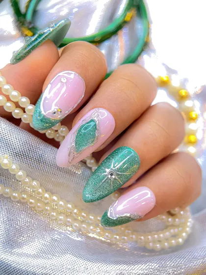 A different perspective of the green and pink Navratri nails, highlighting the almond shape and the beautiful contrast between the glittery green and soft pink.