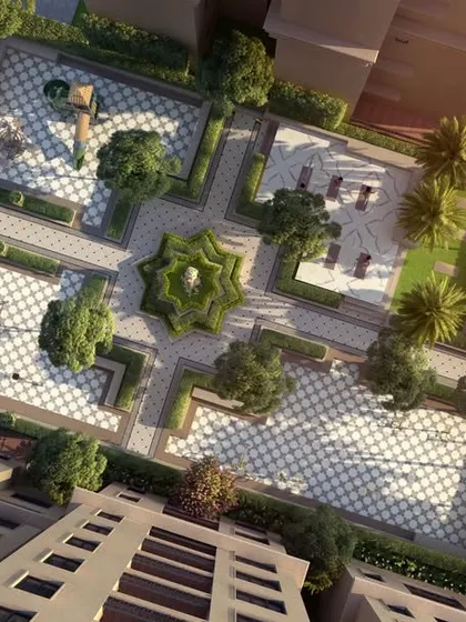 An aerial view of a formal plaza with a star-shaped fountain and checkered paving, demonstrating our skill in creating intricate, geometric hardscapes.