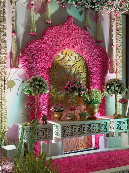 A perfectly symmetrical view of the floral photo corner, showcasing the balance of traditional design, opulent materials, and the sheer abundance of fresh flowers.