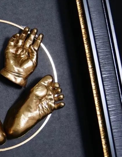 A close look at the fine details you will master. This image highlights the smooth, golden finish on the baby hand and foot impressions and the clean, professional look of the shadow box framing, skills that set your work apart.