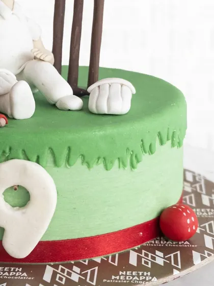Another detail shot of the cricket cake, showing the number nine and the red cricket ball.