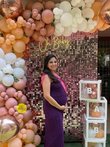 An influencer mom-to-be looking radiant in front of our peach and rose gold sequin wall backdrop. We love when our decor gets the influencer stamp of approval!