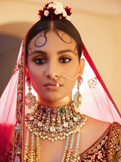 A close-up on bridal beauty. I worked with the makeup artist to create this look, focusing on the traditional "chandrakor" bindi and a statement navratna choker. This highlights my holistic approach, ensuring makeup, hair, and jewellery work in perfect harmony.