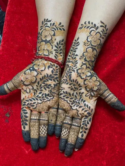 A lovely floral and vine pattern that covers the hands beautifully. The dark stain makes the design pop.