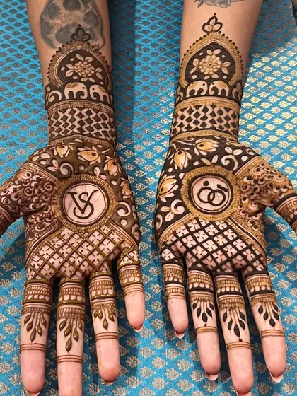 This personalized design was created for a client with existing tattoos. I carefully crafted the mehndi to complement her body art, incorporating her initials and engagement rings.