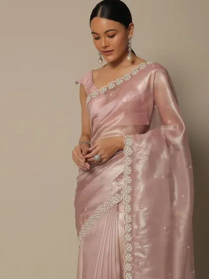A soft and romantic look with a pink organza saree. The makeup is kept dewy and fresh, with a neat low ponytail to create an ethereal and graceful appearance.