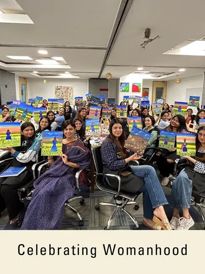 A group of empowered women holding up their creations. My workshops are a great way to celebrate womanhood and team spirit, especially for events like Women's Day.