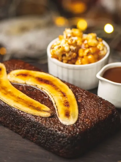 A warm banana bread served with caramelized bananas, caramel popcorn, and a side of toffee sauce. A cozy dessert from my Thanksgiving menu.