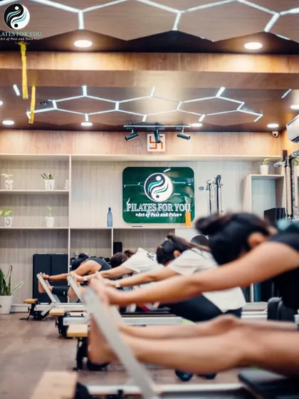 The "Monkey Stretch" on the Reformer is an excellent way to stretch the hamstrings and articulate the spine. This image captures the deep, satisfying stretch our clients experience.