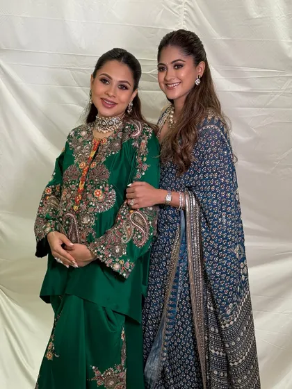 The two beautiful sisters together, one celebrating her baby shower. Their complementary makeup looks are elegant and timeless.