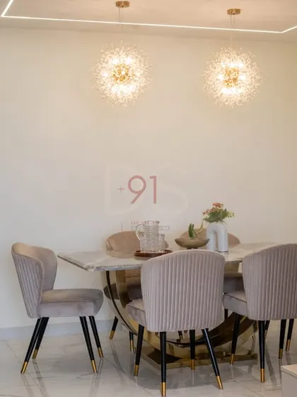 The dining setup is designed for both formal dinners and casual meals, with comfortable seating and beautiful ambient lighting.
