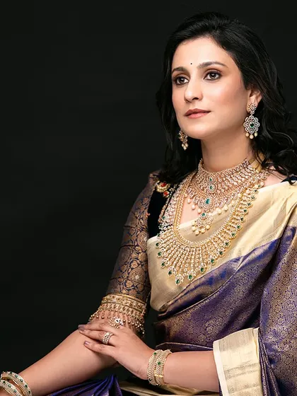 A classic portrait, her gaze direct and confident. The makeup is polished and refined, enhancing her natural bone structure.