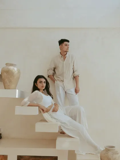 Posed on a minimalist white staircase, this shot has a clean, architectural feel. The couple's relaxed yet poised stances create a sophisticated and modern pre-wedding portrait.