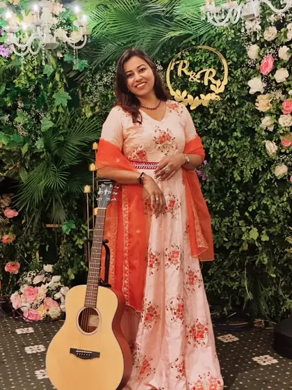 Posing with a guitar against a stunning green wall. It's all about capturing the vibe of the event.