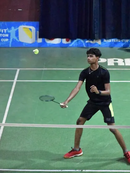 A young player in a focused stance during a match, showing the mental toughness we build alongside physical skill.