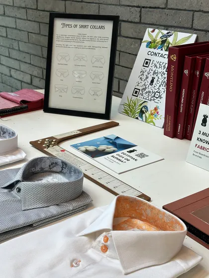 A table of our custom shirt offerings at the BCG trunk show. Details like contrasting inner collar fabric and custom button colors allow for true personal expression.