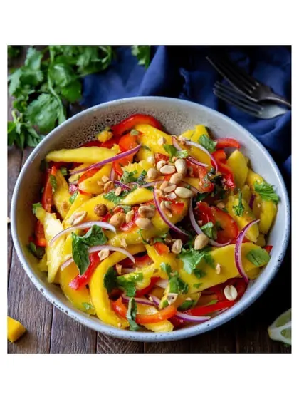 A vibrant and tangy Mango Salad, perfect for the summer. It's a refreshing mix of sweet mangoes, crunchy peanuts, and fresh herbs.