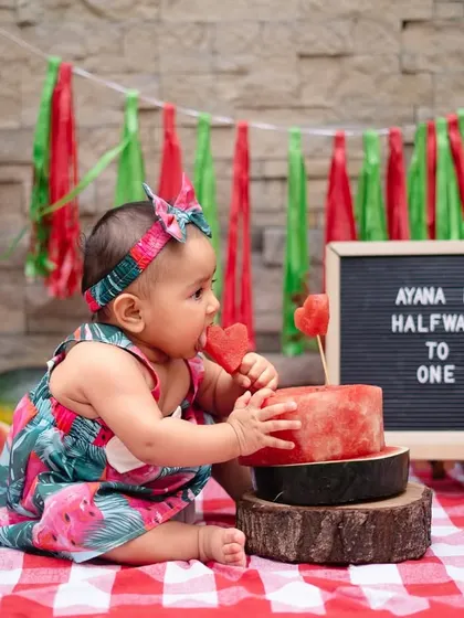 Celebrating six months with a sweet and juicy watermelon smash. This is a fun, colorful, and unique alternative to a cake smash, perfect for capturing that "halfway to one" milestone.