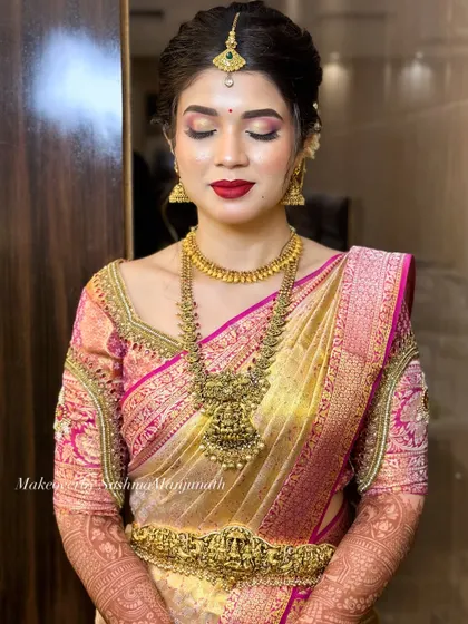 A classic bridal look featuring a bold red lip and soft gold eyeshadow. This timeless combination is perfect for a traditional wedding ceremony.