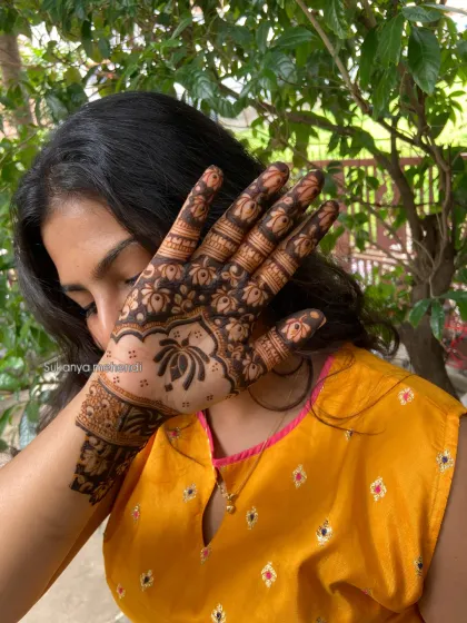 Enhancing her beauty with a simple yet stunning design on the back of her hand. This shows how even a smaller piece can make a big impact.