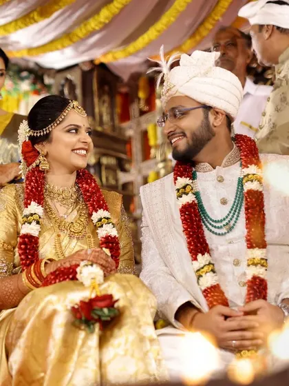 A warm, candid shot of the couple sharing a look by the light of the holy fire during their Hindu wedding ceremony.
