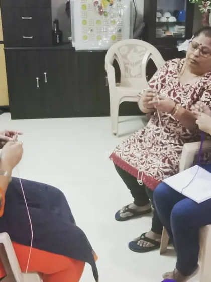 Here you can see a typical class setting where I'm helping two students at once. We create a comfortable, friendly atmosphere where everyone can learn at their own pace and feel supported.