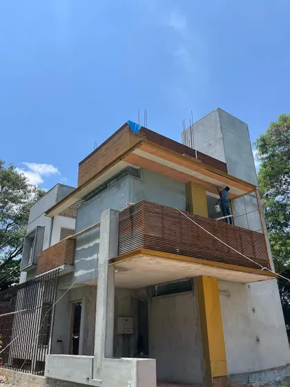 The house under construction, with its strong geometric forms.