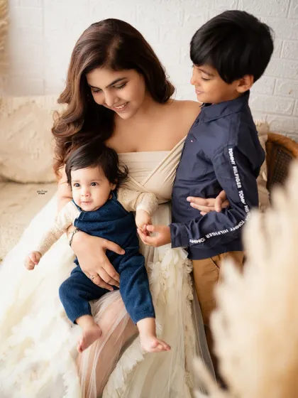 A mother's loving embrace for both her sons, big and small.
