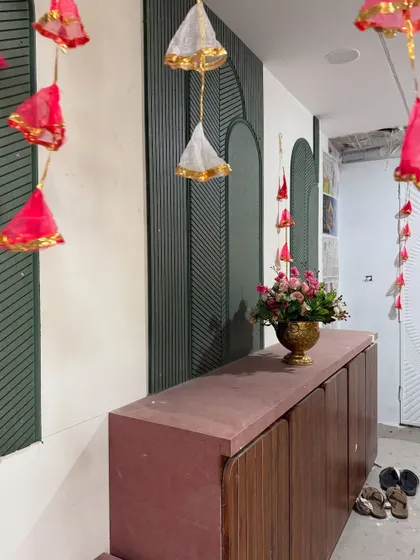 Simple yet charming decor elements, like these hanging fabric tassels and a single floral arrangement, can transform any corner of a home for a Mehendi function.