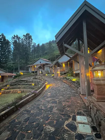 The TARA boutique resort in Kotagiri at dusk. I used locally sourced stone for the pathways and reclaimed wood for the structures to create a space that feels timeless and deeply connected to the Nilgiri hills.