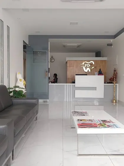 A wide view of the clinic's waiting lounge, showing the sleek furniture and serene color palette of grey, white, and wood tones.