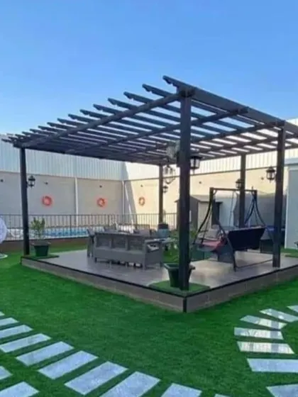 A poolside pergola setup creating a shaded lounge area. Our expertise with over 2000 projects allows us to design functional and beautiful outdoor spaces for any need.
