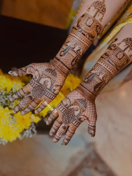 A full view of the traditional design, showing how the motifs on the arms connect with the peacock designs on the palms.