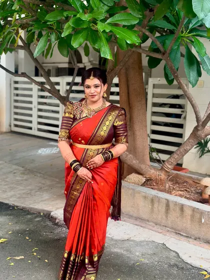 A full-length shot showcasing the entire bridal ensemble. The makeup is balanced to look perfect with the heavily embroidered blouse and traditional jewelry.