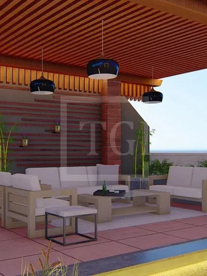A close-up of the covered lounge area in the Gurgaon project, complete with a bar, comfortable sofas, and modern hanging lights.