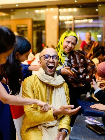 The groom's reaction to his custom mehendi is priceless. Ashwin's friends had "Drama B*tches for life" written on his palm, and the shock and laughter made for a great photo.