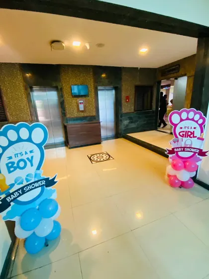 Simple and clear signage for a gender reveal baby shower, with 'It's a Boy' and 'It's a Girl' cutouts placed at the entrance.