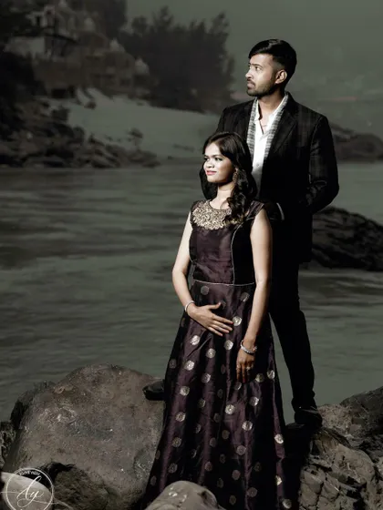 A dramatic pre-wedding portrait taken by the water in Rishikesh. The couple's pose is strong and poised, creating a powerful image that feels like a still from a movie.
