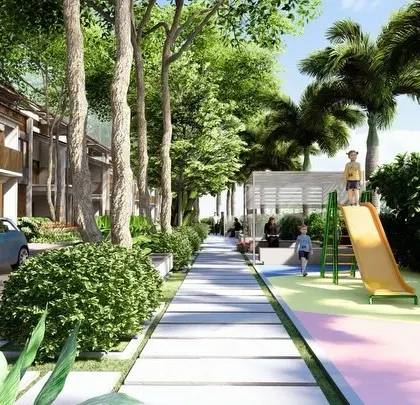 A linear park in a villa community, featuring a dedicated play zone with a slide and spring riders, safely situated alongside a pedestrian walkway and away from vehicle traffic.