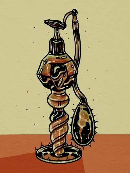 A vintage-style atomizer perfume bottle with a thorny base and bulb.