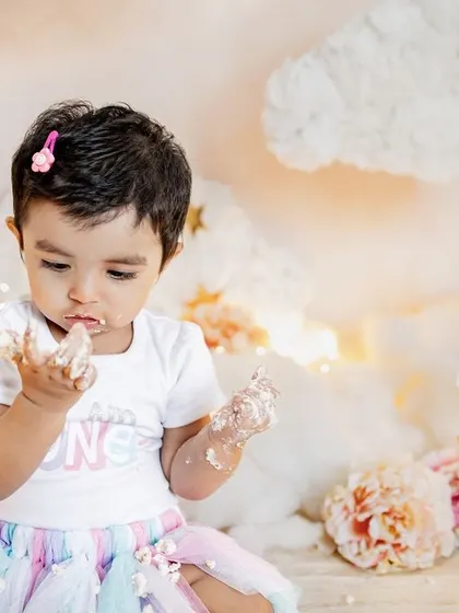 This little one is proud to be one and isn't afraid to get messy. The "I am ONE" shirt and a face full of frosting make for the perfect cake smash photo.