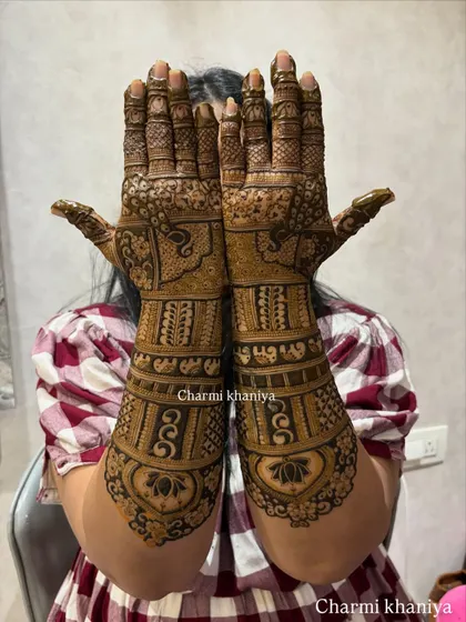 Mehendi vibes all the way! This design features a beautiful lotus at the base of the palm, with intricate patterns and peacock motifs extending up the arm.