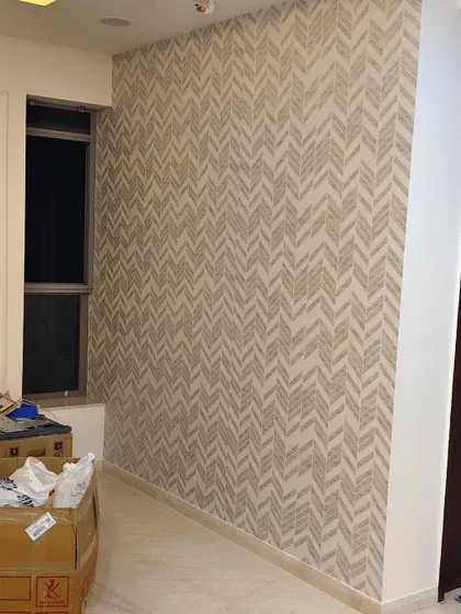 A simple chevron or herringbone pattern wallpaper in neutral tones. This is a classic geometric pattern that adds subtle interest to a wall.