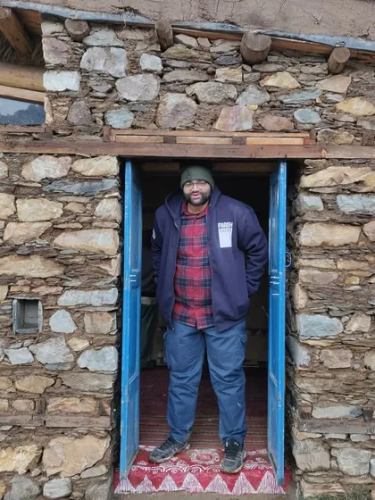 **People of Compartment S4: Monik Shah:** Monik at a project site in a rural, stone-built structure. His work is about capturing the untold stories of the people and places we design for.