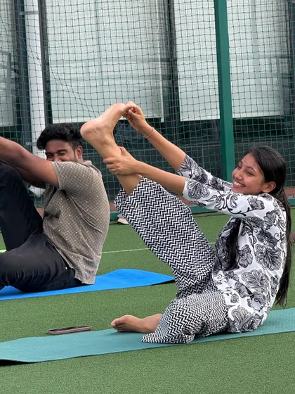 Laughter and focus go hand in hand. During this partner stretch at the Withum session, employees helped each other deepen their poses, building both flexibility and camaraderie.