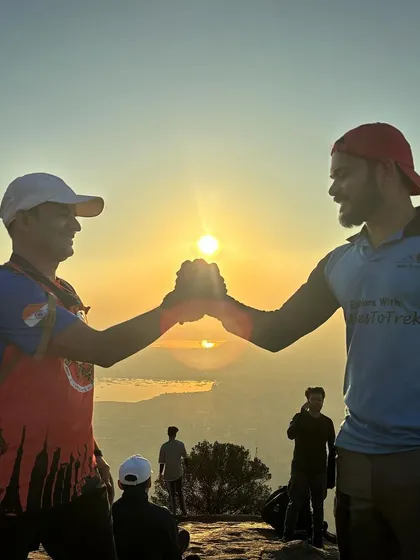A handshake of success between two leaders at sunrise. This image symbolizes the partnership and teamwork that we embody and promote.